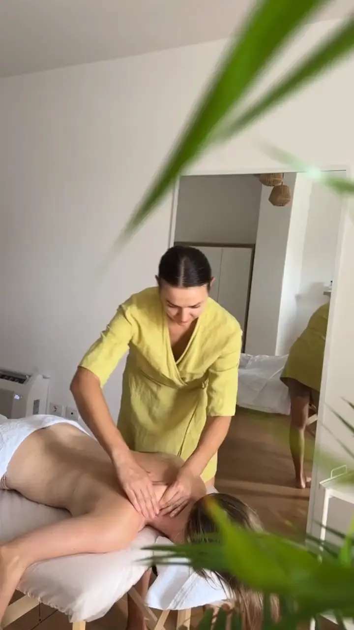 Full-body massage session at Sundara Studio with plants in the foreground