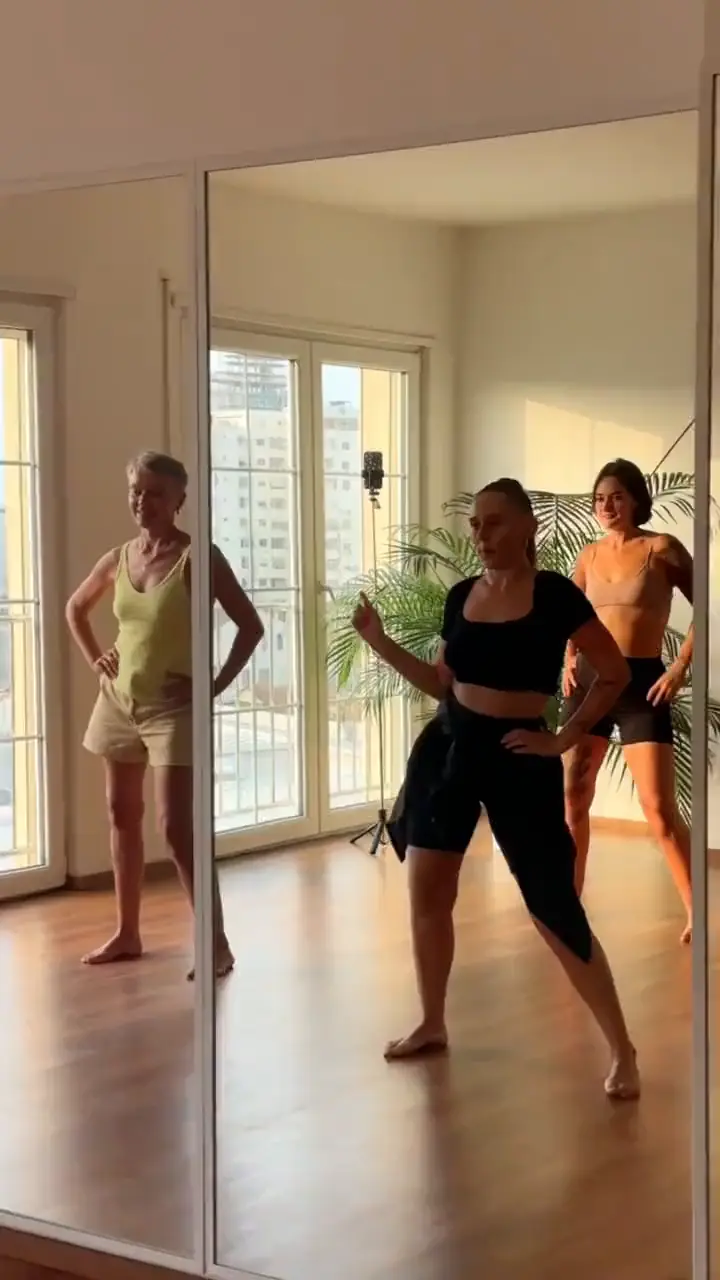 Dance class moving together in the bright mirrored room at Sundara Studio