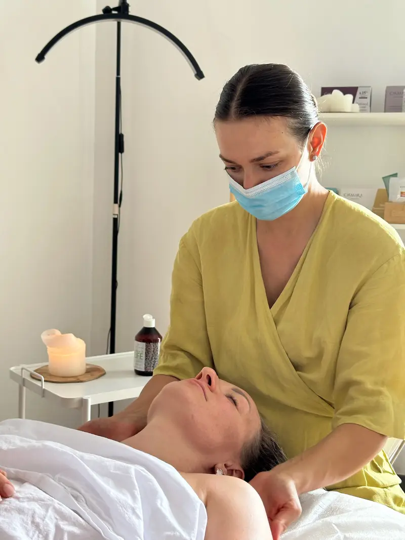 Cosmetologist massaging the neck and shoulders of a relaxed client